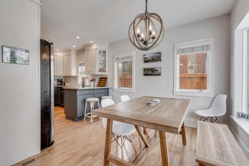 a kitchen and dining room with a wooden table and chairs at Lakefront Cottage in Excelsior