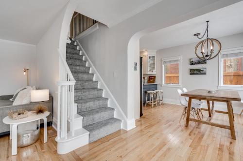 a living room with a staircase and a table at Lakefront Cottage in Excelsior