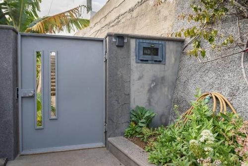 a white door in the side of a building at Vivenda Carlota Sea View by Mth in Ribeira Brava