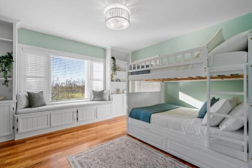 a bedroom with two bunk beds and a window at The Orchard in Hugo