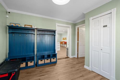 an empty room with blue cabinets and a hallway at The Orchard in Hugo