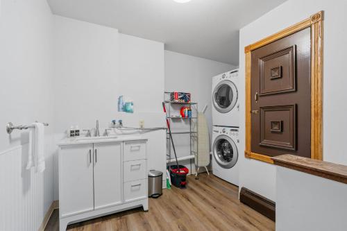 a bathroom with a sink and a washing machine at The Orchard in Hugo