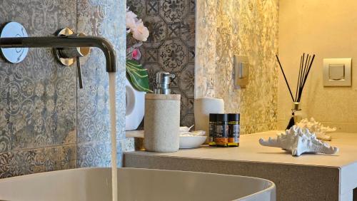 a sink with a faucet on top of a counter at Efi's Apartments in Plaka Milou