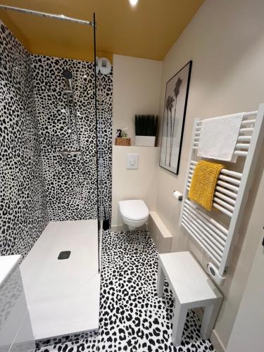 a bathroom with a black and white checkered floor at Le Cézembre, au pied de la plage in Saint Malo