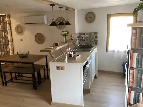 a kitchen with a table and a counter top at Appartement de charme Saint-Romain in Saint-Romain