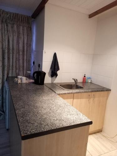 a kitchen with a sink and a counter top at Klagesoek in Vosburg