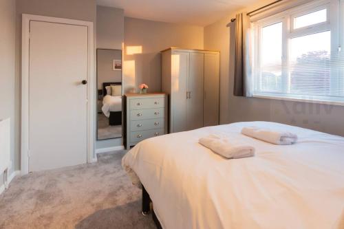 a bedroom with a bed with two towels on it at Pet-Friendly Coastal Home by Adliv in Broadstairs