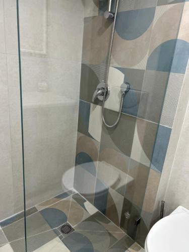 a shower with a glass door in a bathroom at מקום על הים in Jlil