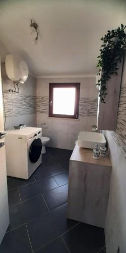 a bathroom with a sink and a toilet at House Sa Sedda in Carbonia