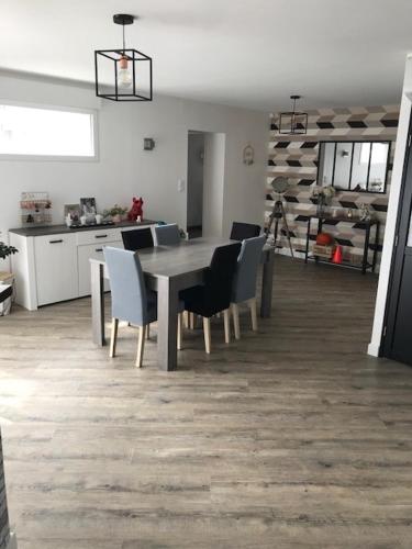 une salle à manger avec une table et des chaises dans une cuisine dans l'établissement Maison a Changé, à Changé