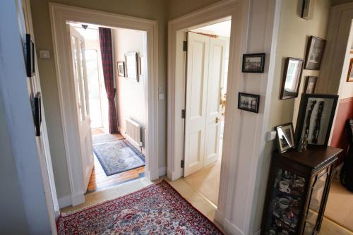 a hallway with two doors and a rug at The Old Manse Oyne in Oyne