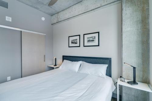 a bedroom with a white bed and a large window at Sable 602 - Alcove in Minneapolis
