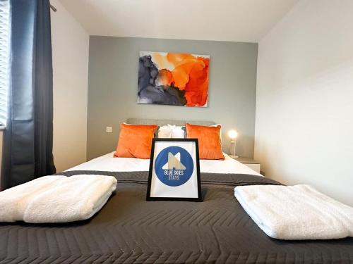 a bedroom with a bed with a sign on it at Ayresome House By Blue Skies Stays in Middlesbrough