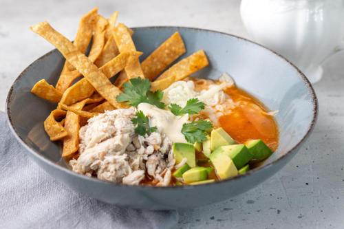 a bowl of food with chips and meat and vegetables at Pumilio Mountain & Ocean Hotel in Jacó