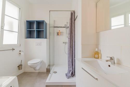 une salle de bain blanche avec des toilettes et un lavabo dans l'établissement Aix Historique La Tour de l 'Horloge, à Aix-en-Provence