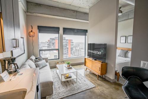 a living room with a couch and a tv at Sable 801 - Alcove in Minneapolis