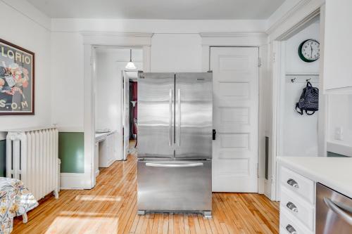 a kitchen with a stainless steel refrigerator in it at The Fitzgerald in Saint Paul