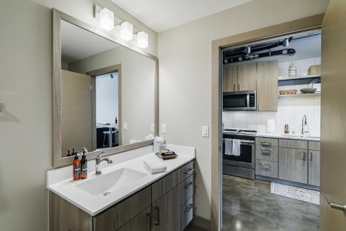 Un baño con lavabo y un espejo grande. en Sable 803 - Alcove, en Minneapolis