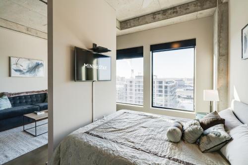 a bedroom with a bed and a large window at Sable 803 - Alcove in Minneapolis