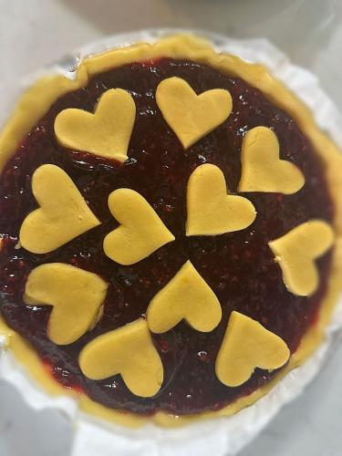 a pie with heart shaped cookies on top of it at Cascina Spazio Indaco in Castagnole Monferrato