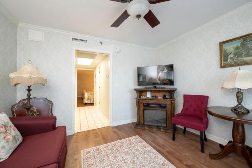 a living room with a couch and a table at Boardwalk Plaza Hotel in Rehoboth Beach