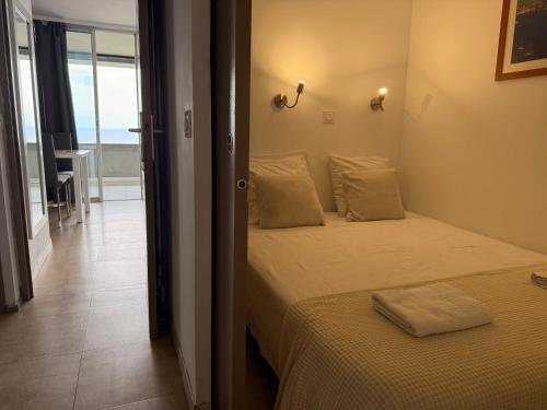a bedroom with a bed and a view of the ocean at Sunny Home Costa Plana-Monaco -Cap D'Ail in Cap d'Ail