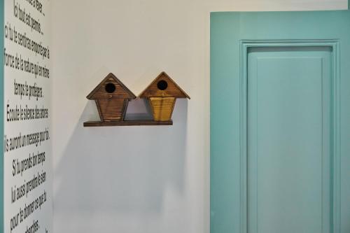 a pair of birdhouses on a wall next to a door at Beit Tamanna Guesthouse in Beirut