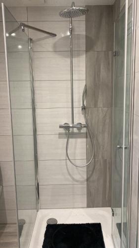 a bathroom with a shower with a glass door at Hostel Apartment in Castrop-Rauxel