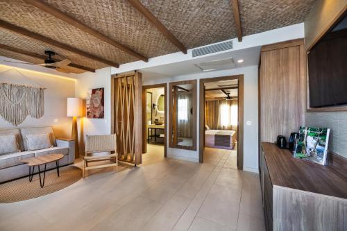 a living room with a couch and a table at Hotel Riu Palace La Mola in Playa Migjorn