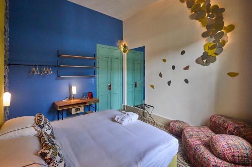 a bedroom with a bed and a blue wall at Beit Tamanna Guesthouse in Beirut