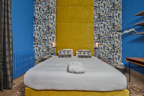 a bedroom with a large bed with two pillows at Beit Tamanna Guesthouse in Beirut