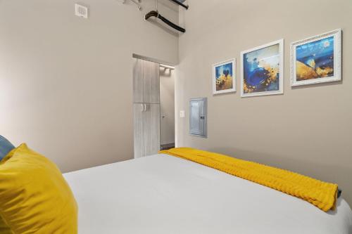 a bedroom with a white bed with a yellow blanket at Sable 604 - One Bedroom in Minneapolis
