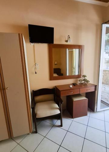 a room with a desk and a chair and a mirror at Villa Michalis Goulis in Liapades
