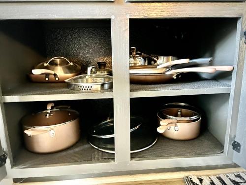a cupboard filled with pots and pans and dishes at Huge Home near Old Folsom Pet & Family Friendly in Folsom