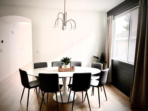 a dining room with a white table and chairs at Huge Home near Old Folsom Pet & Family Friendly in Folsom