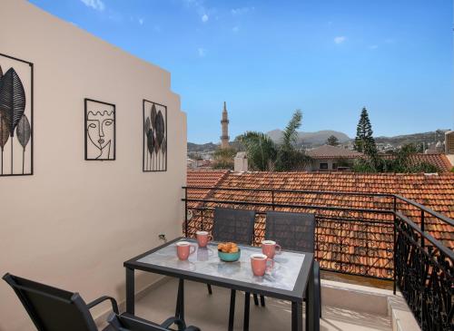a table and chairs on a balcony with a view at Mosaico Cozy House in Rethymno Town