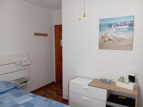 a bedroom with a bed and a picture of a beach at B&B Rena Majore con piscina privata! in Rena Majore