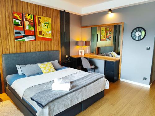 a bedroom with a bed and a desk in it at Visit Poznan in Dąbrówka