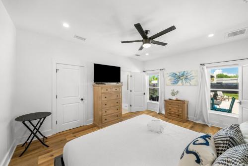 a bedroom with a bed and a flat screen tv at Pet Friendly Beach House - 6th Street Retreat by Panhandle Getaways in Port Saint Joe