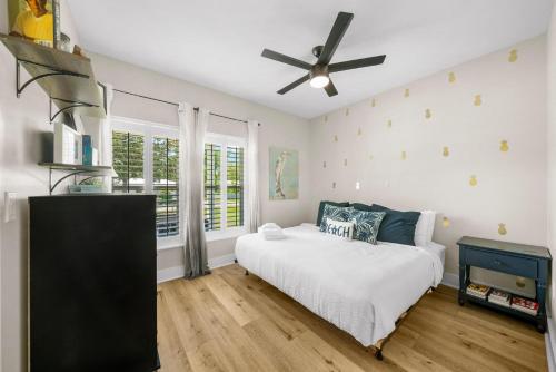a bedroom with a bed and a ceiling fan at Pet Friendly Beach House - 6th Street Retreat by Panhandle Getaways in Port Saint Joe