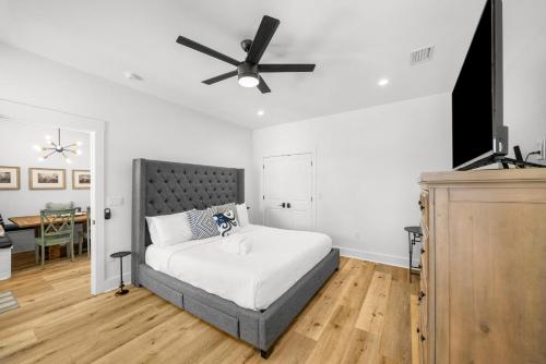 a bedroom with a bed and a ceiling fan at Pet Friendly Beach House - 6th Street Retreat by Panhandle Getaways in Port Saint Joe