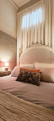 a bedroom with a large white bed with a window at Alma House - Caminha in Caminha