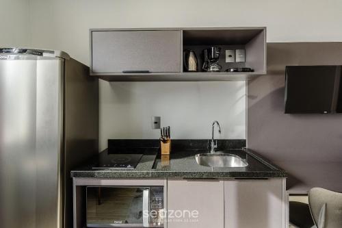 a kitchen with a sink and a counter top at TCO - Apartamentos no Centro Histórico Porto Alegre/RS in Porto Alegre