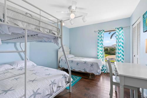 a bedroom with two bunk beds and a desk at Walk to the Beach & Everywhere! Private Pool! in Henry Key
