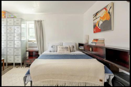 a white bedroom with a large bed in it at 2 bedroom Apt in Kingston
