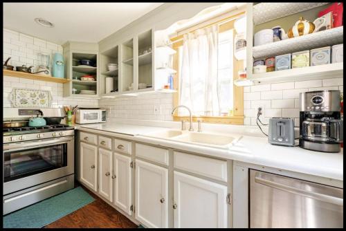 a kitchen with white cabinets and a sink at 2 bedroom Apt in Kingston