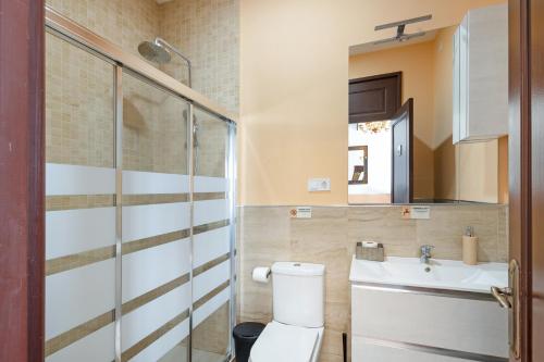 a bathroom with a toilet and a sink at Masa La Bomba in Premiá de Mar