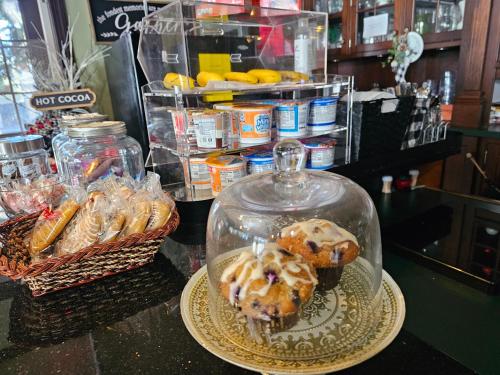 a table with a glass jar with muffins on a plate at The Culpepper Inn in Elizabeth City