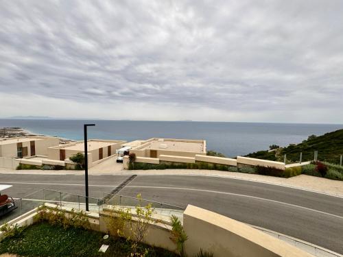 an empty road with a view of the ocean at TIS, Green Coast in Palasë