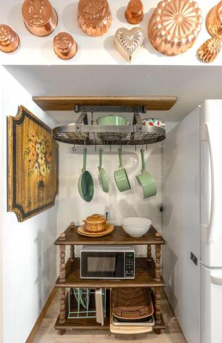 a kitchen with a table with a microwave and utensils at Chickadee Suite in Cashmere